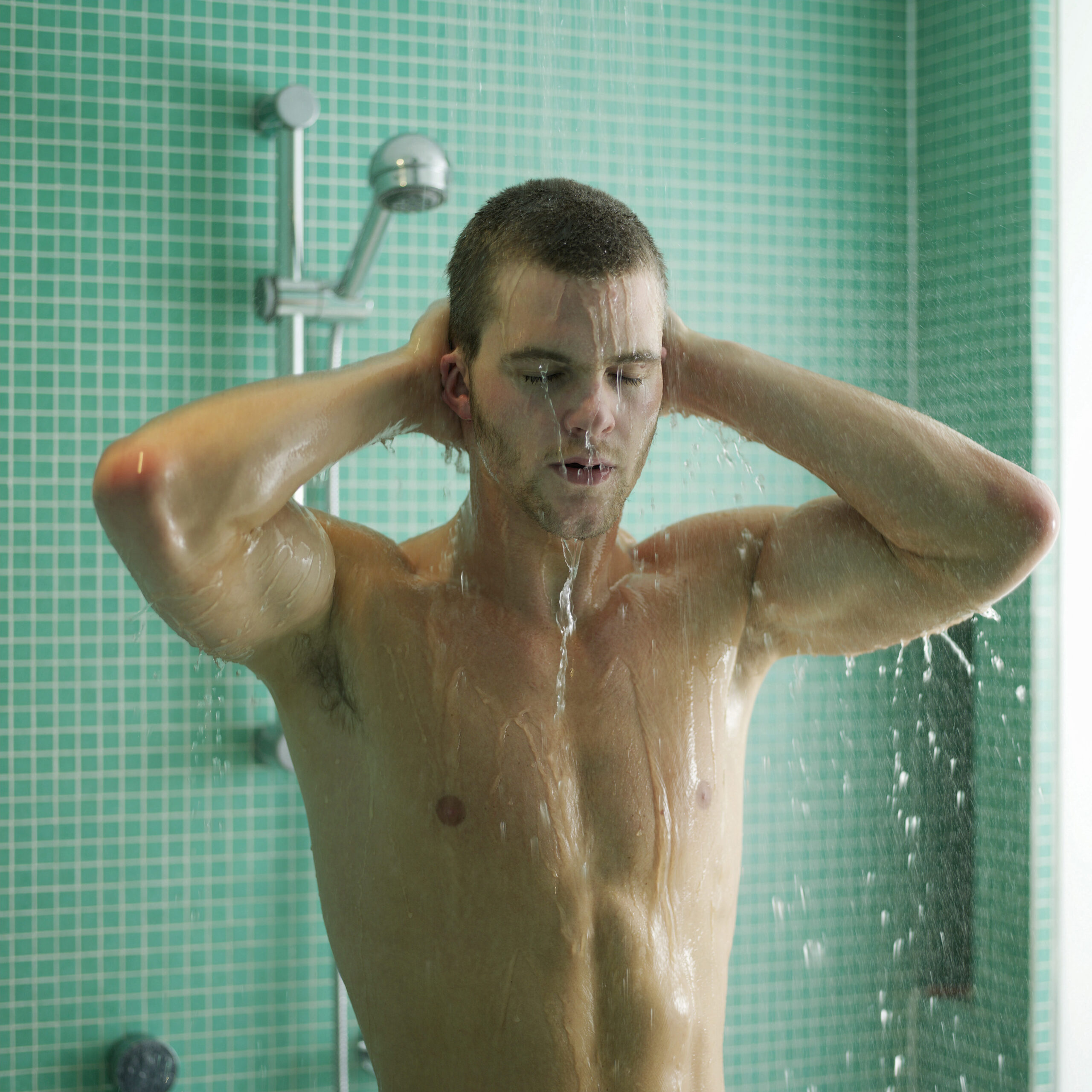 A man is enjoying water heater shower