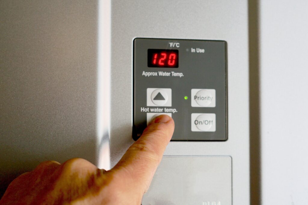 finger-on-hot-water-heater-control-unit-2022-11-16-00-04-45-utc-awda