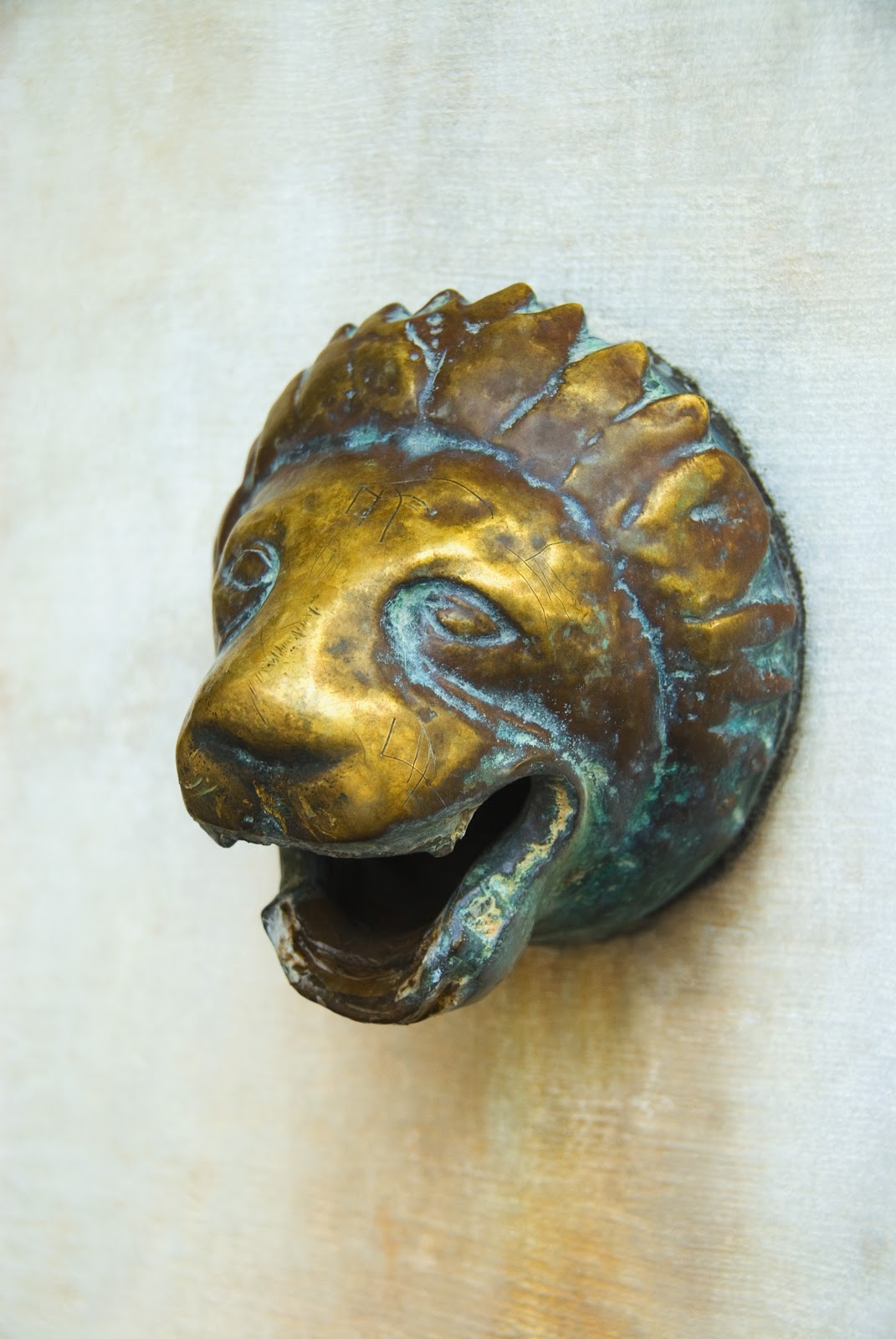 Close-up of a lion's head shaped water outlet on a wall, Athens, Greece