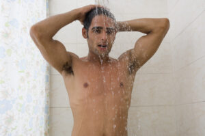 A man taking shower with hot water