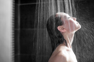 A woman enjoying hot water shower