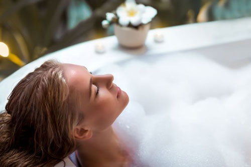 A woman enjoy relaxing bath using hot water
